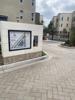 a sign on the side of a brick sidewalkat Westbury Apartments, Rancho Cucamonga